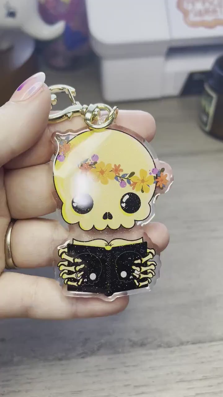 Cute Skeleton Reading Sparkly Acrylic Keychain Charm